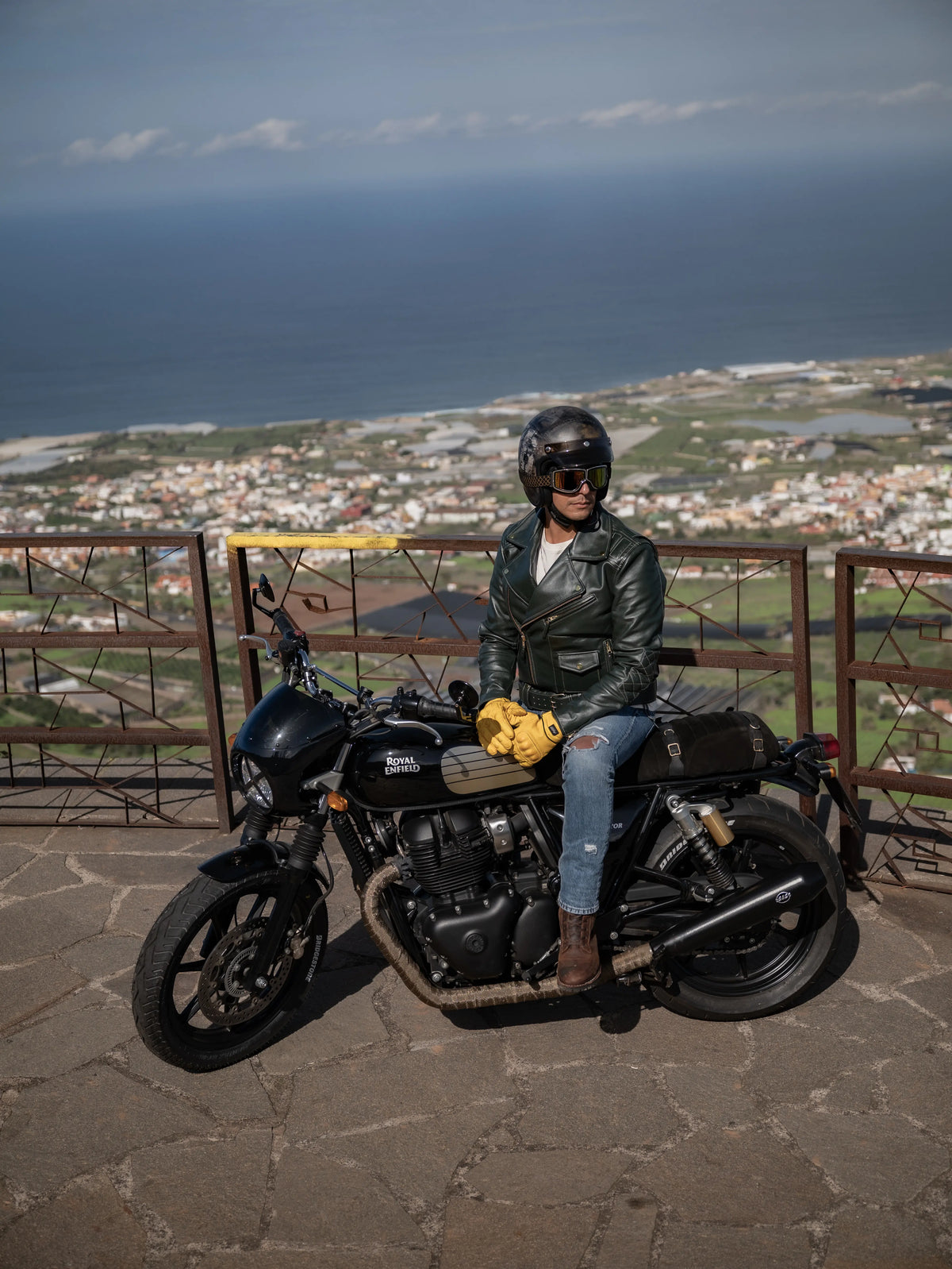Person sitting on a motorcycle with a scenic background
