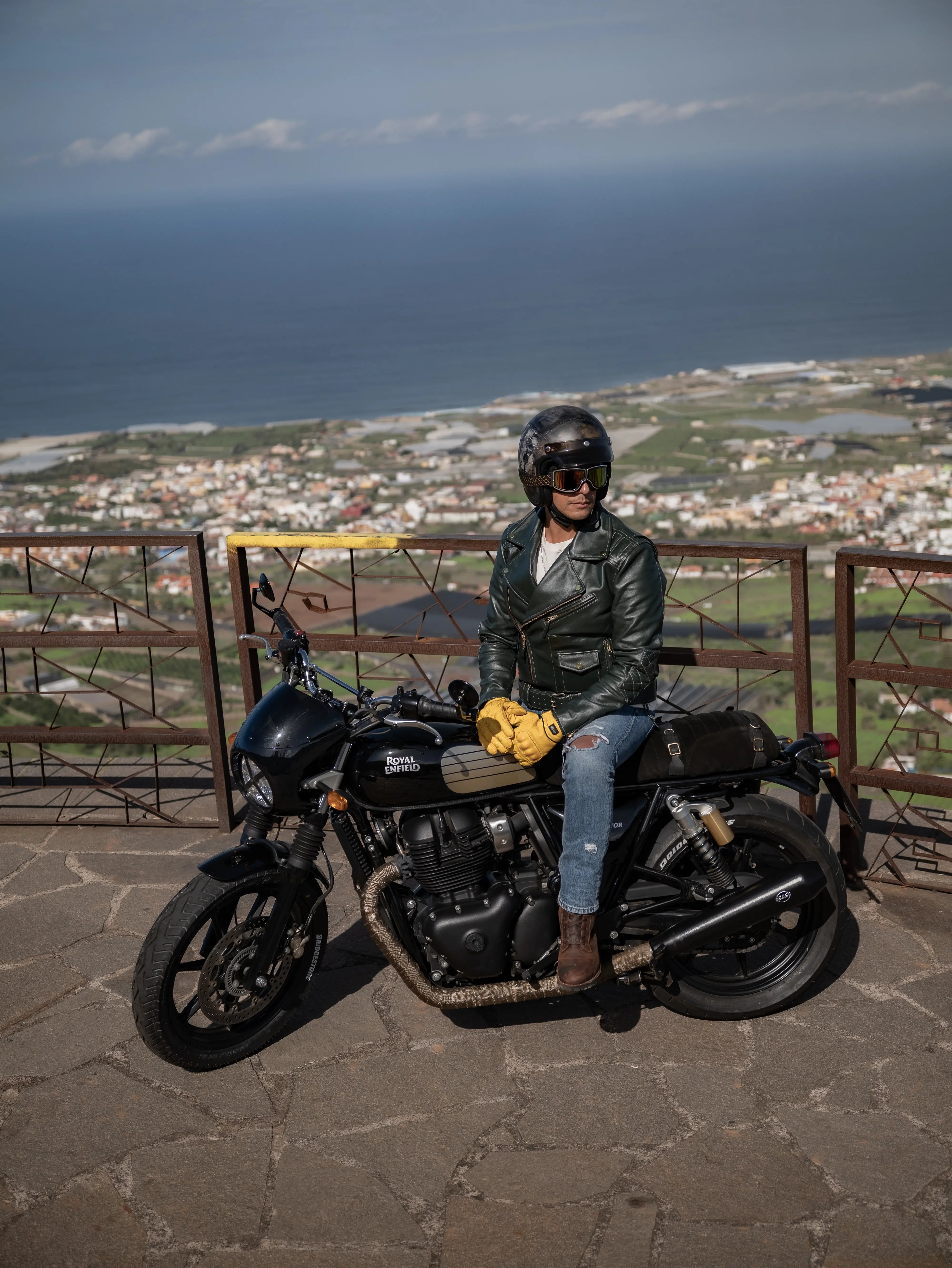 Person sitting on a motorcycle with a scenic background