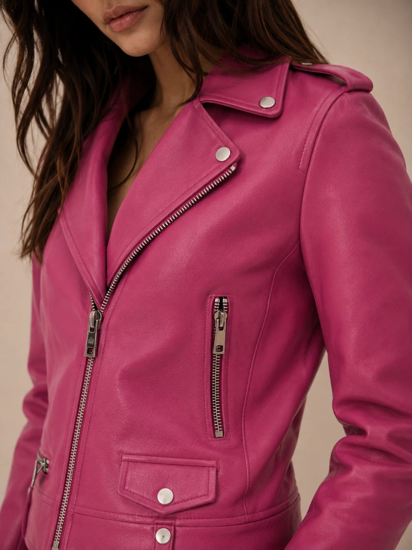 Close-up of a pink leather jacket with zippers on a neutral background