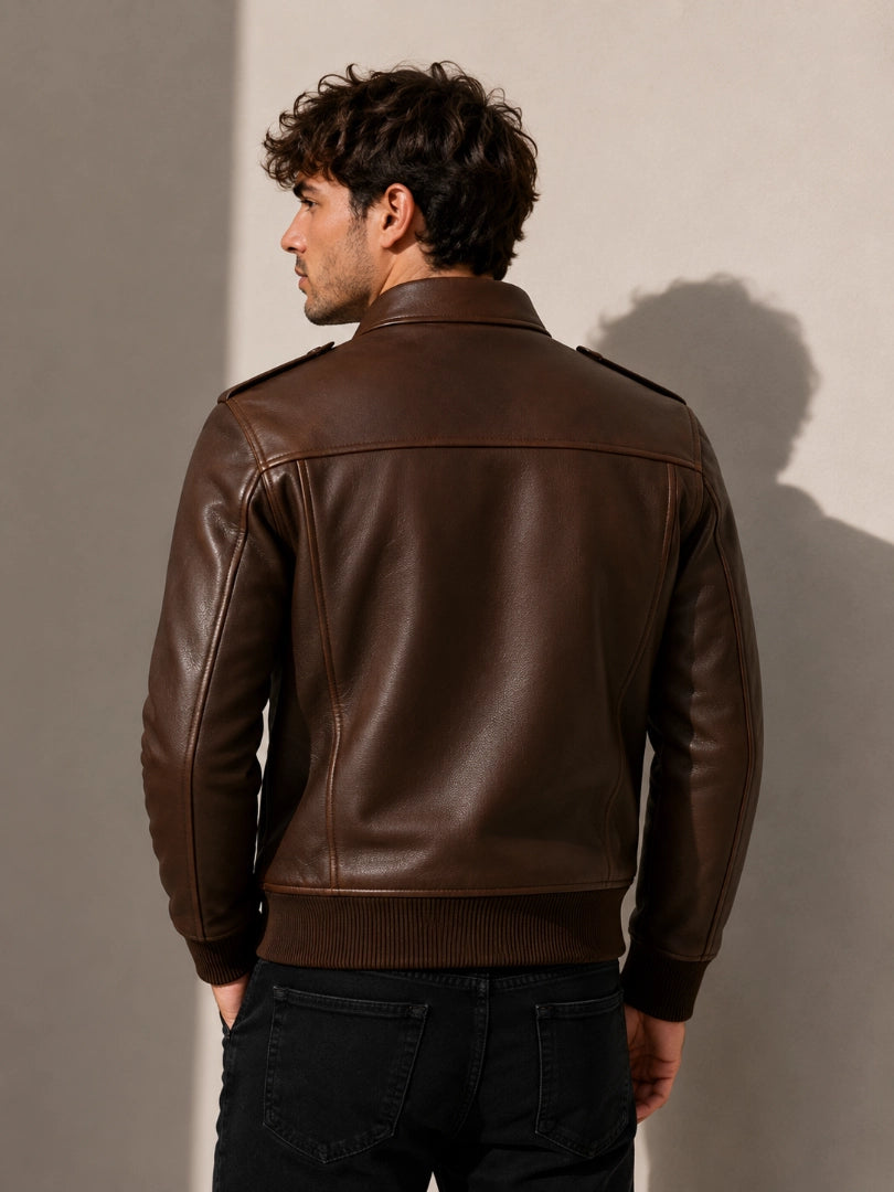 Man wearing a brown leather jacket against a plain background