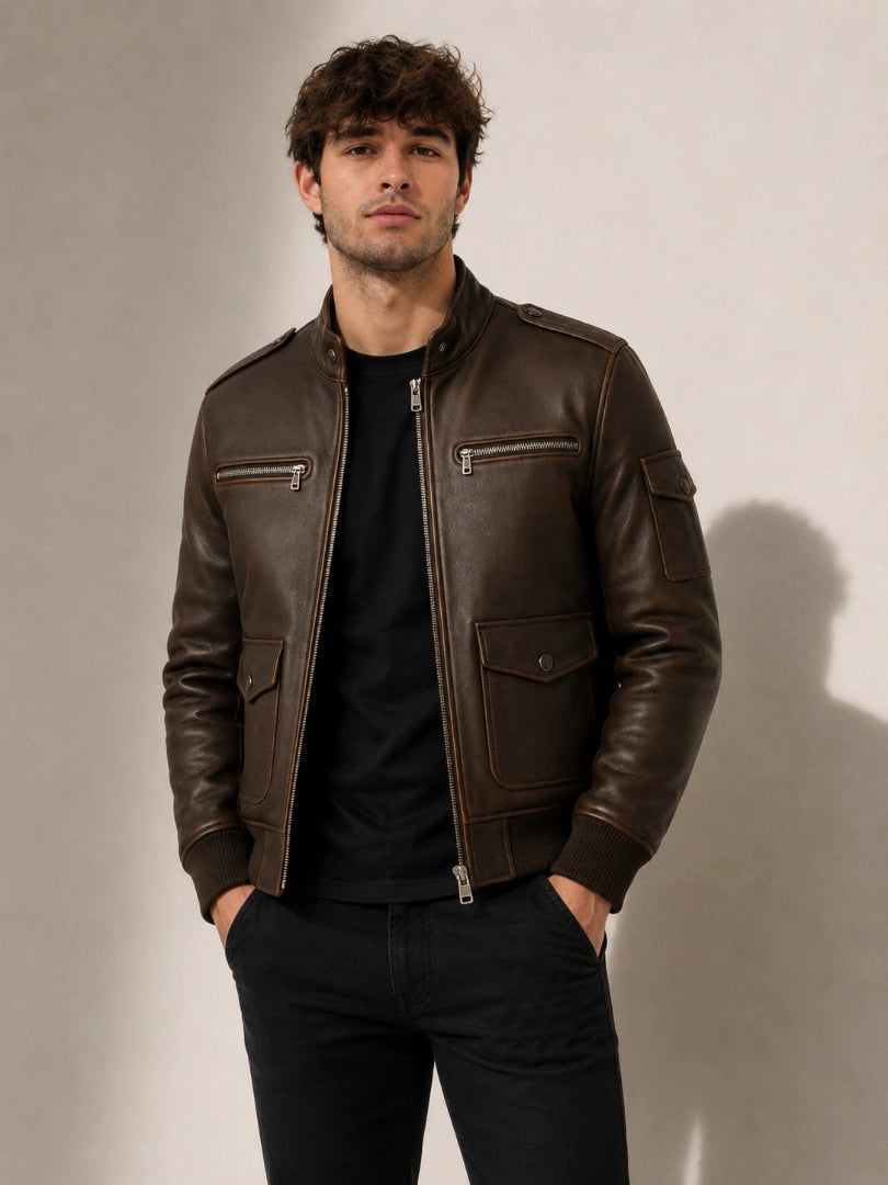 Man wearing a brown leather jacket against a plain background