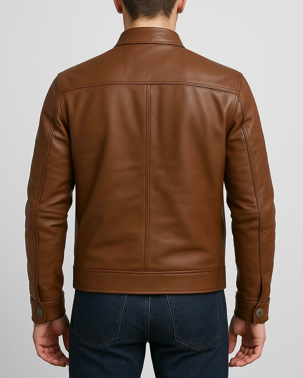 back view of a Brown leather jacket worn by a person on a light gray background
