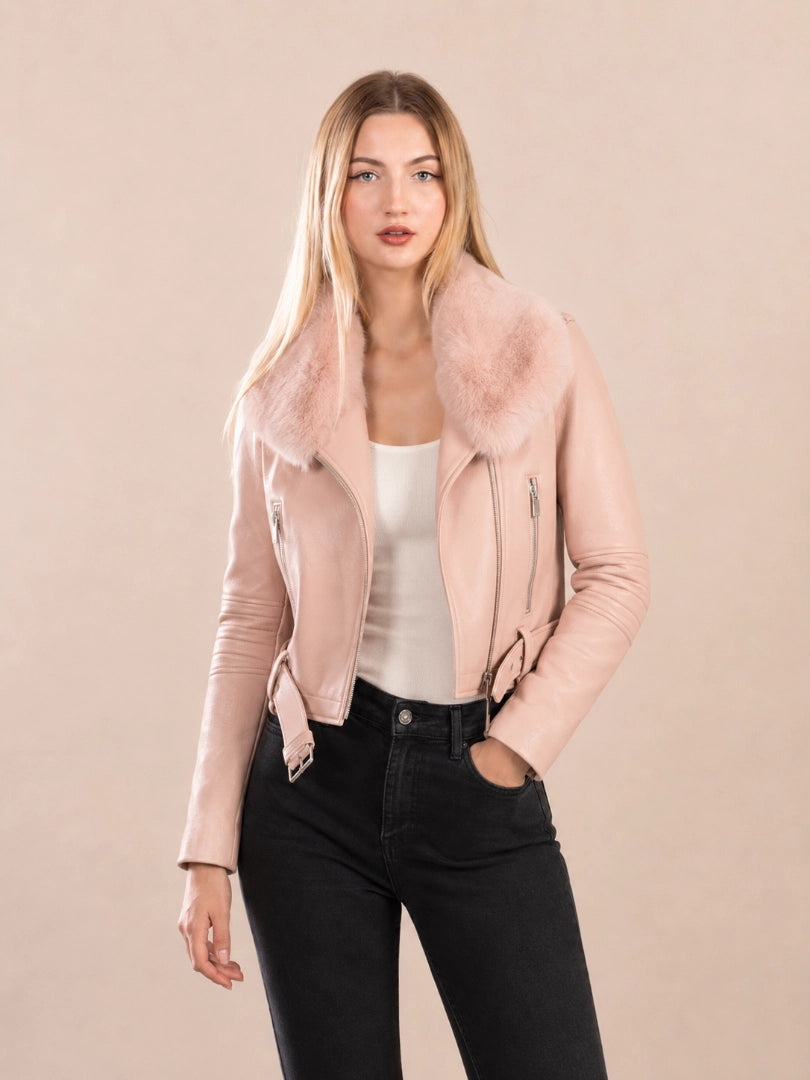 Woman wearing a pink jacket with fur collar against a beige background