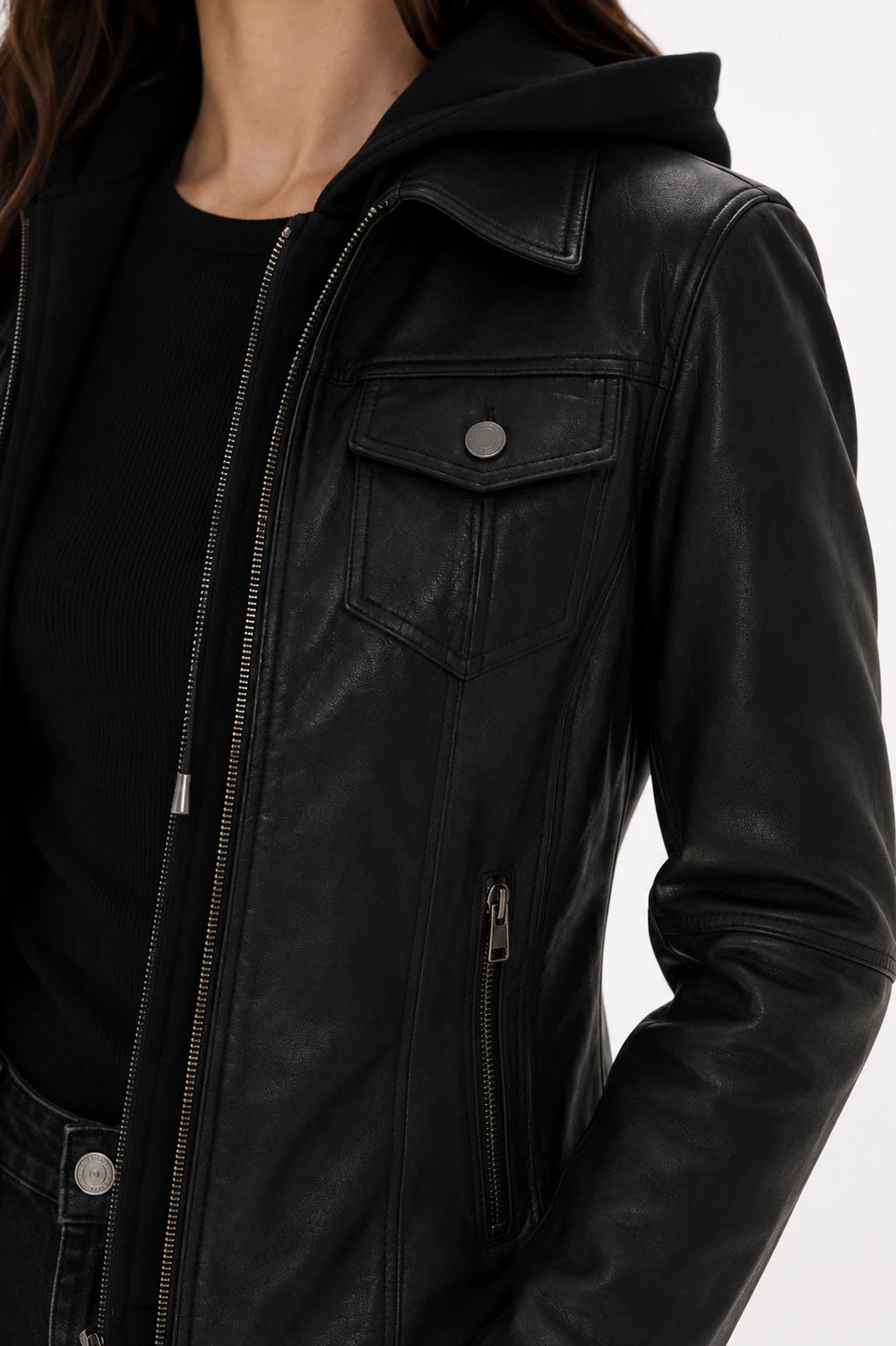 Close-up of a black leather jacket with a hood on a white background