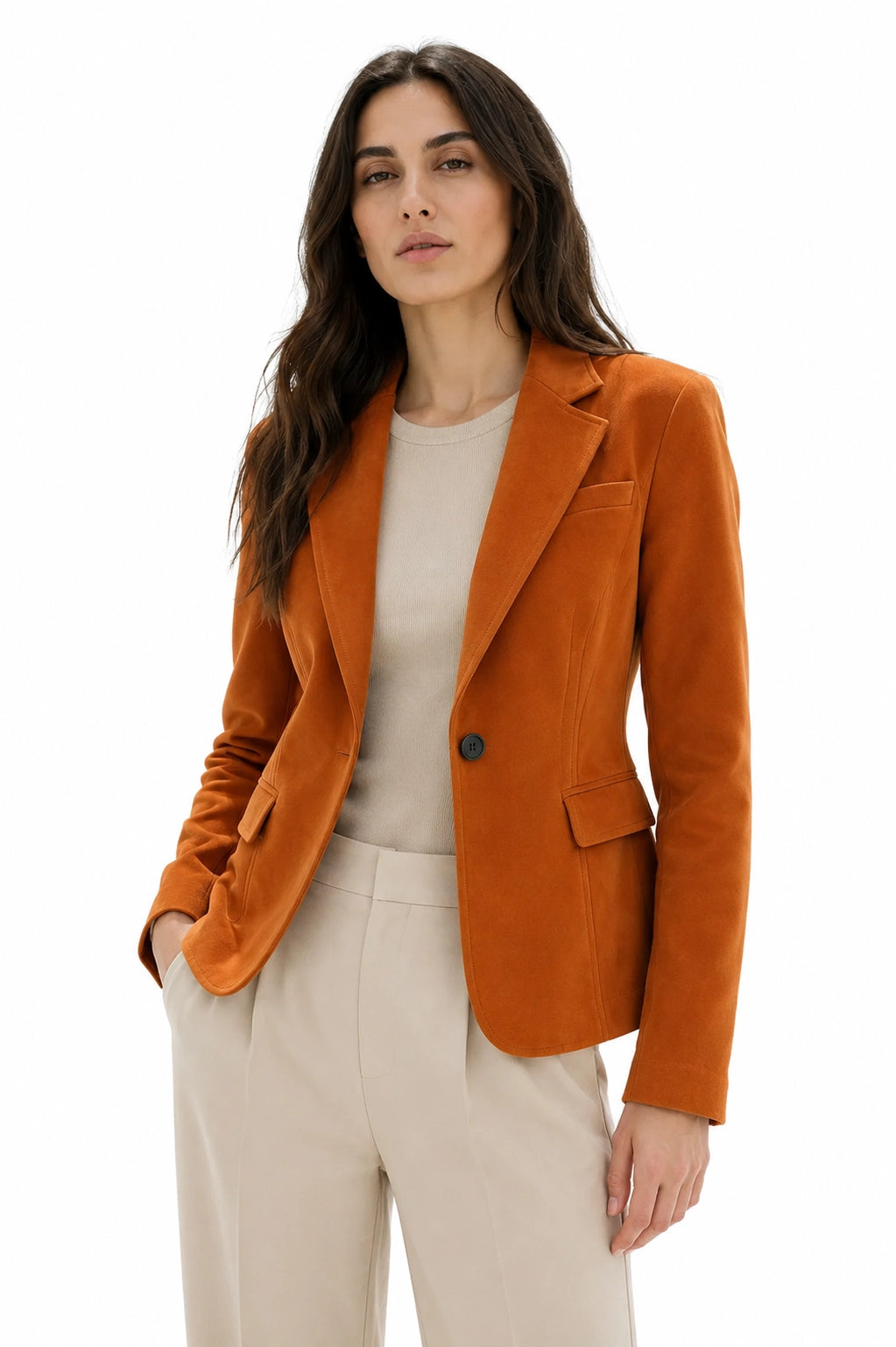 Woman wearing an orange blazer over a beige top and pants on a white background