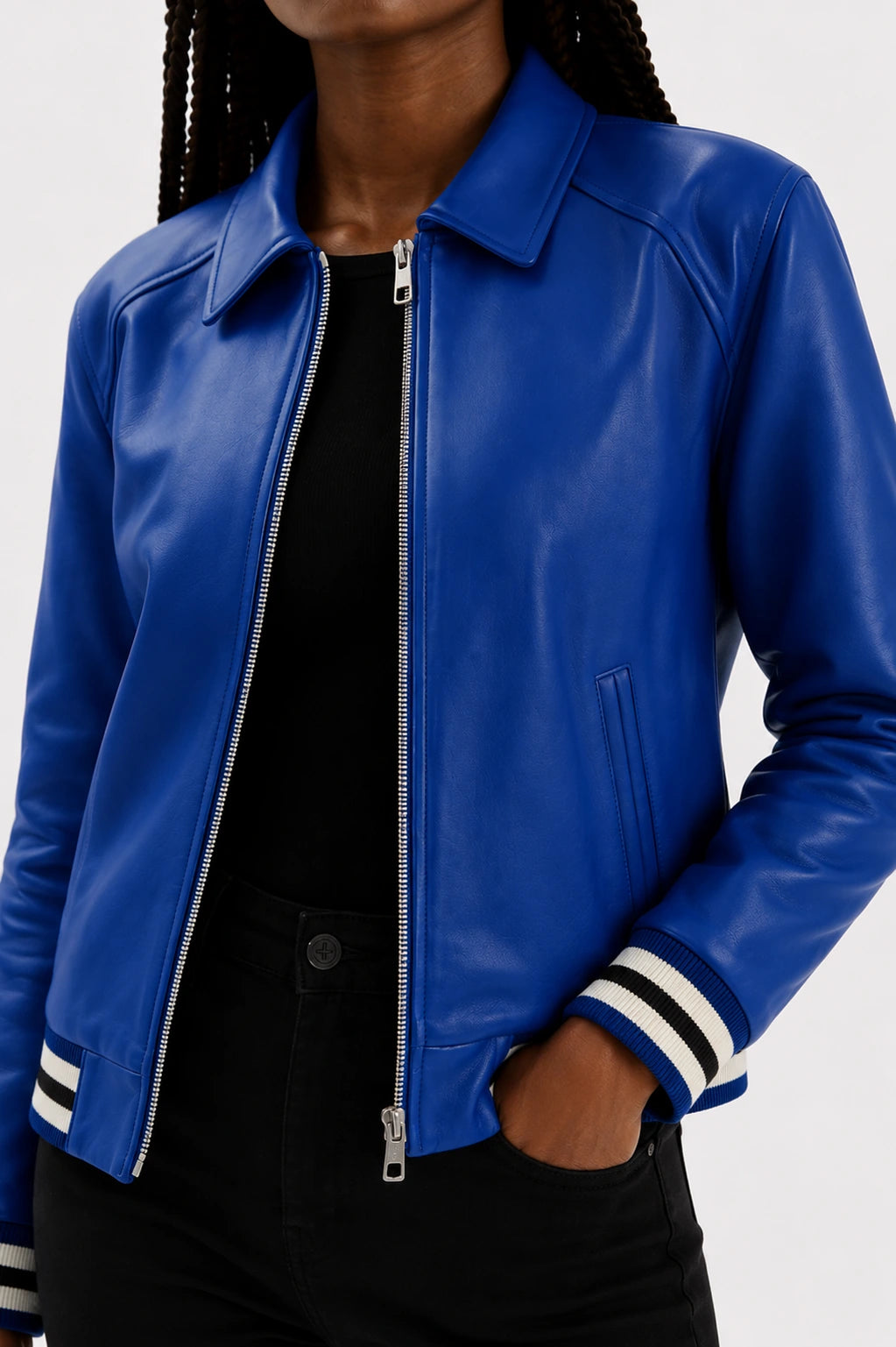 Blue leather jacket with white accents worn by a person on a white background