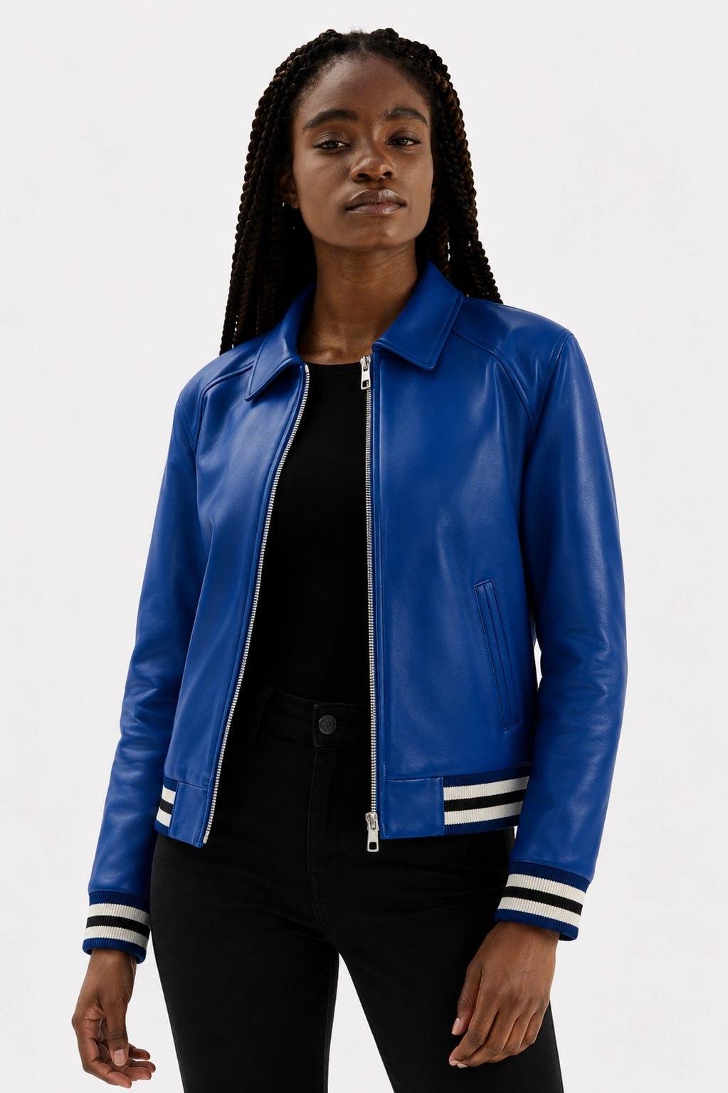 Woman wearing a blue leather jacket with black pants on a white background