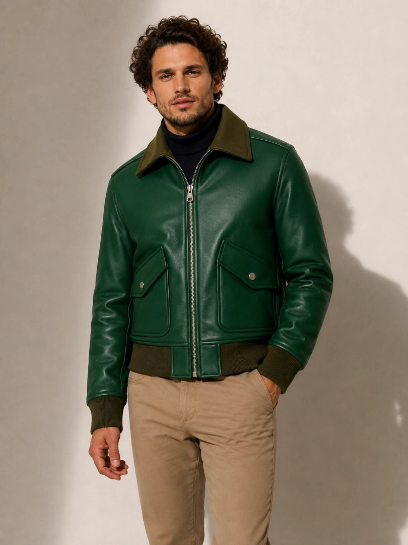 Man wearing a green leather jacket against a plain background