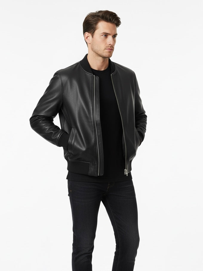 Man wearing a black leather jacket and black pants on a white background