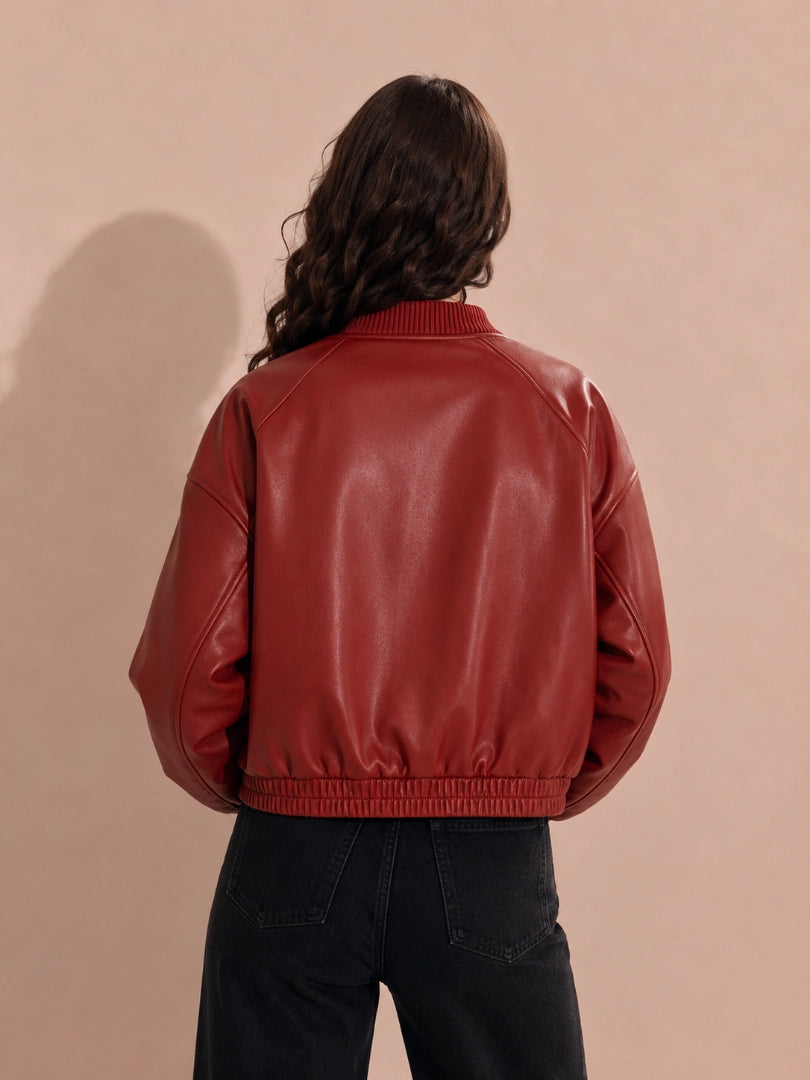 Person wearing a red leather jacket against a beige background
