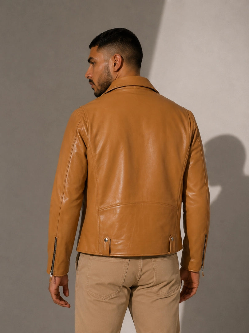 Man wearing a tan leather jacket against a plain background