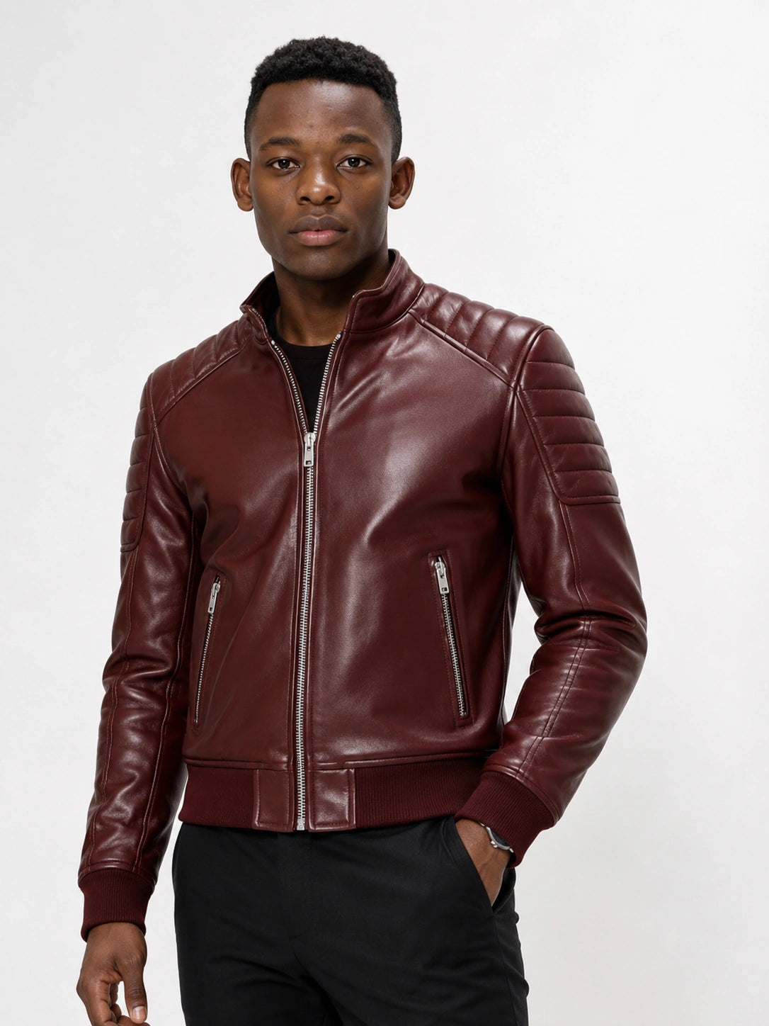 Man wearing a maroon leather jacket on a white background