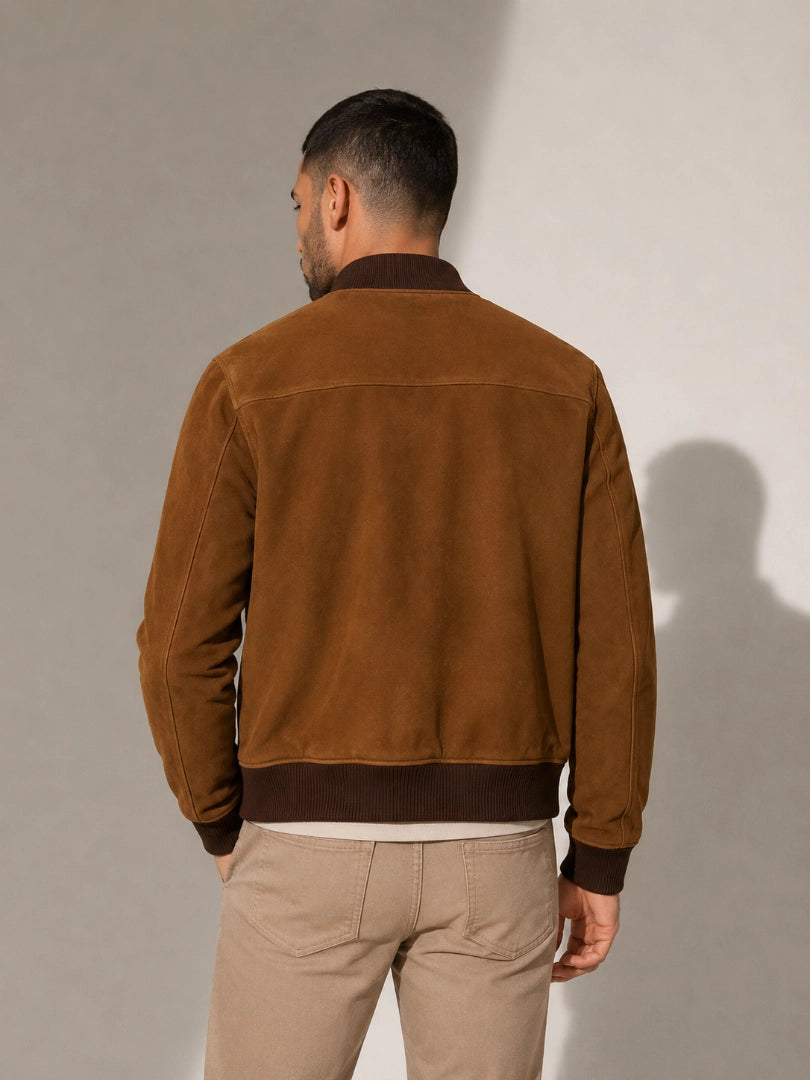Man wearing a brown suede jacket against a plain background
