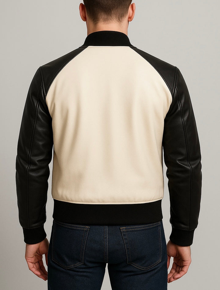 back view of Man wearing a black and beige jacket with leather sleeves on a gray background