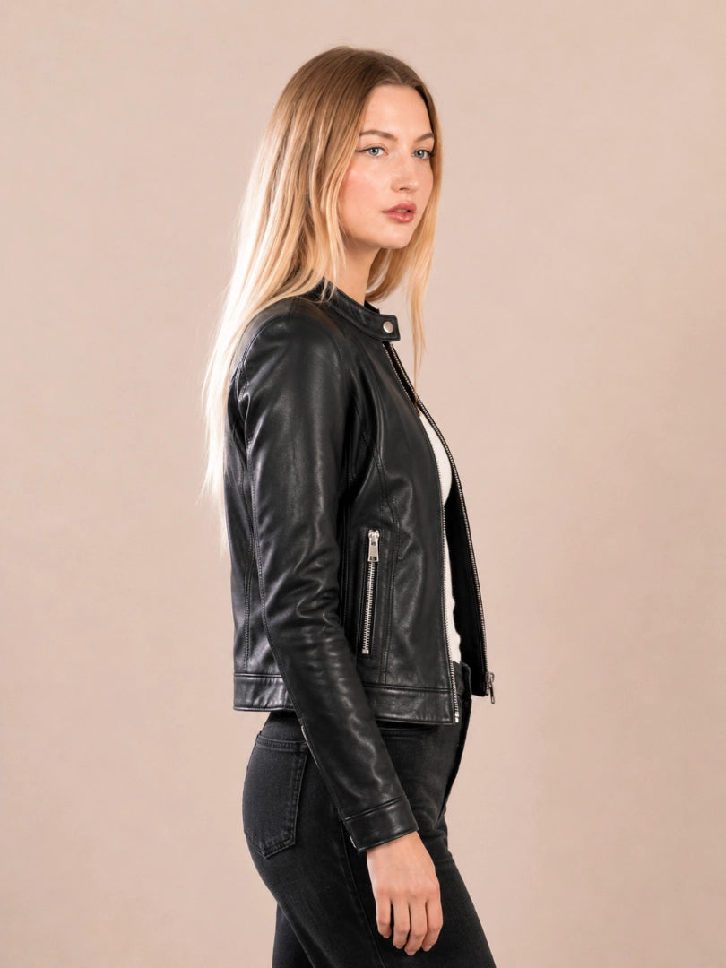 Woman wearing a black leather jacket against a beige background